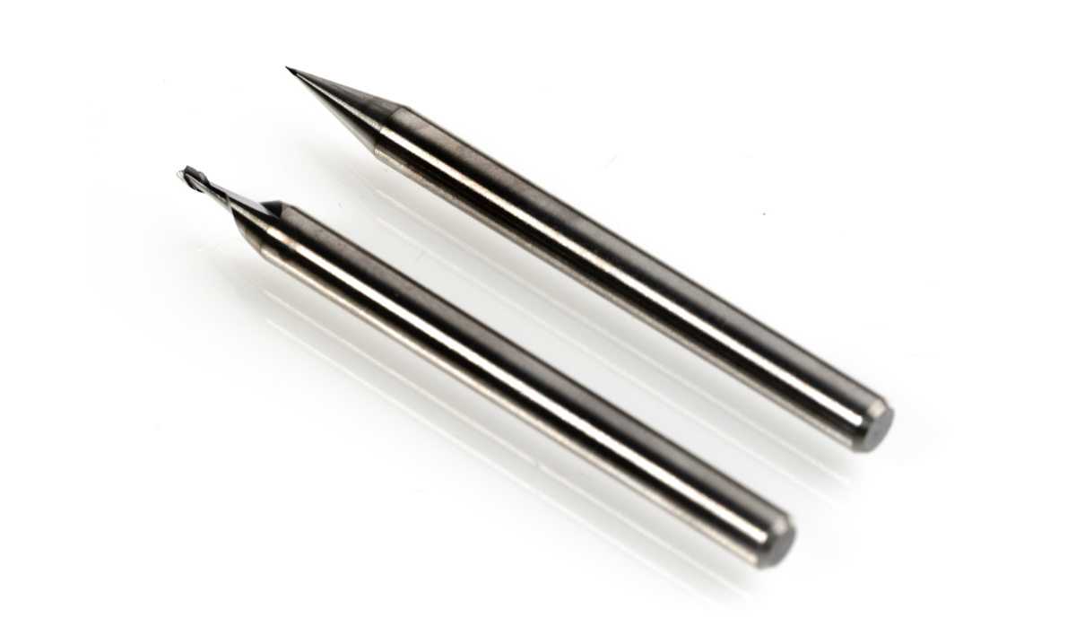 A 1 millimeter and a 100 micrometer diameter end mill.