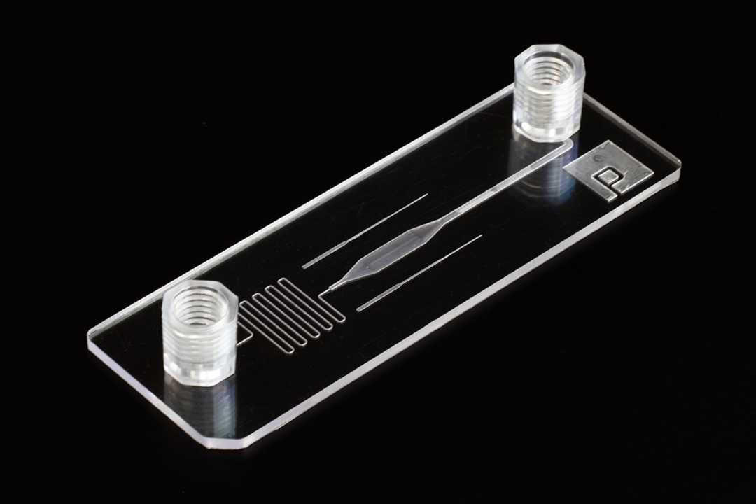 A slide format microfluidic device that is micromilled. The device is transparent with smooth surfaces. Smaller features are still somewhat hazy.