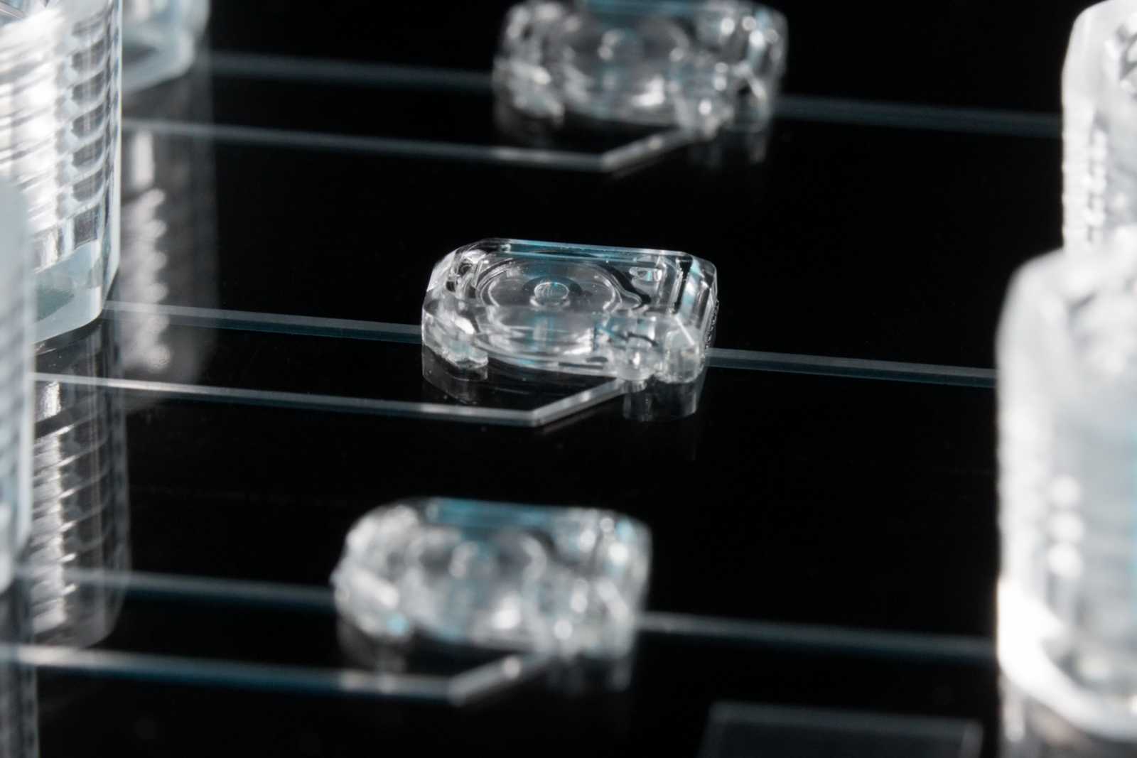 Three MV-2 microvalves on a microfluidic device. Channels connect the microvalves to the 1/4-28 ports next to them.