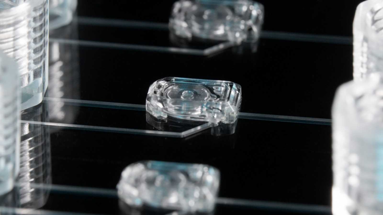 Three MV-2 microvalves on a microfluidic device. Channels connect the microvalves to the 1/4-28 ports next to them.